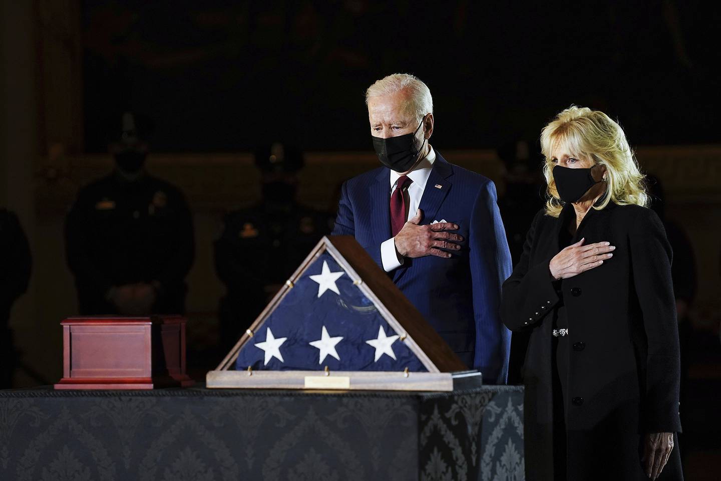 President Joe Biden and first lady Jill Biden pay their respects to the late U.S. Capitol Police officer Brian Sicknick as an urn with his cremated remains lies in honor on a black-draped table at center of Capitol Rotunda, Tuesday, Feb. 2, 2021, in Washington.