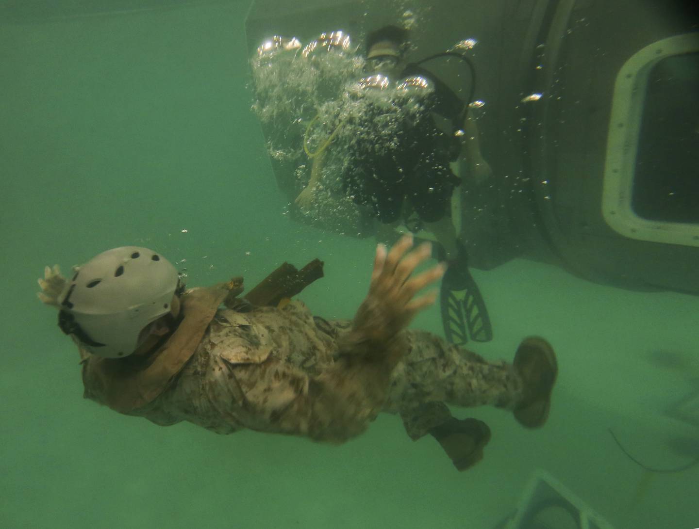 A Marine with the 26th Marine Expeditionary Unit conducts evacuation procedures out of a Modular Amphibious Egress Trainer during underwater egress training at the water survival training center aboard Marine Corps Base Camp Lejeune, N.C., March 24, 2015.