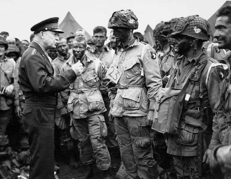 U.S. Gen. Dwight D. Eisenhower, left, gives the order of the day to paratroopers in England prior to boarding their planes to participate in the first assault of the Normandy invasion.