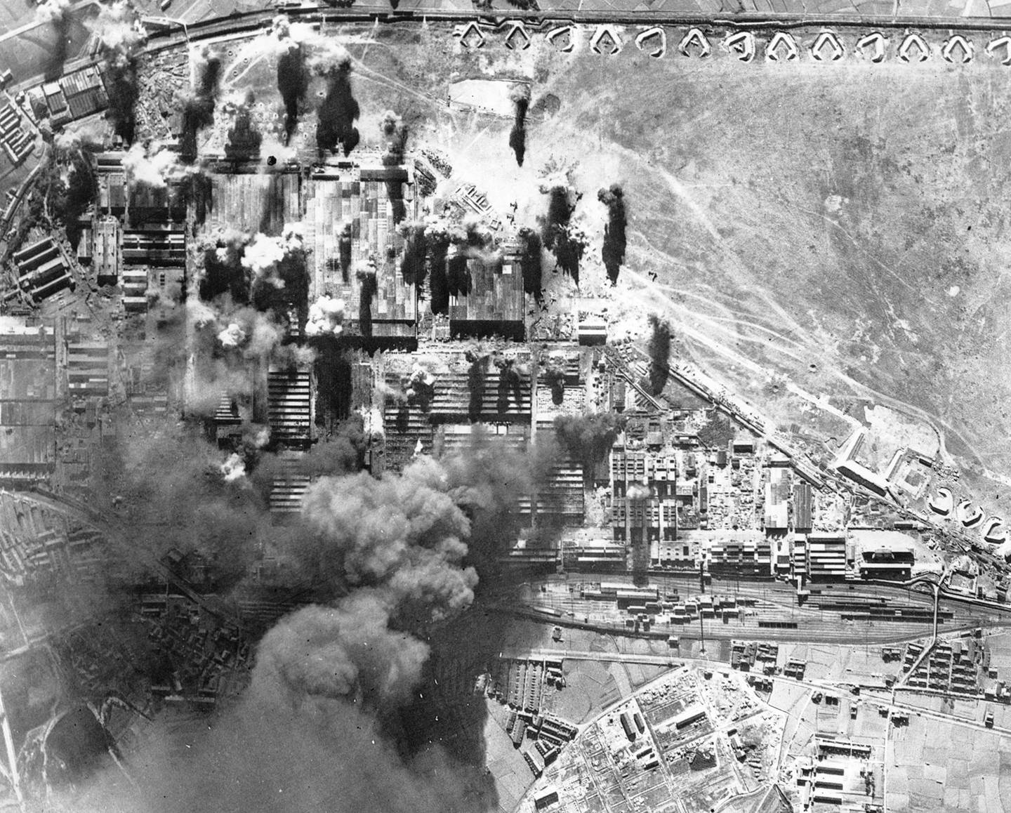 In this Jan. 19, 1945, file photo, black smoke rises from burning targets at the Kawasaki aircraft plant in Kawasaki, near Tokyo, as U.S. planes bomb the factory facilities.