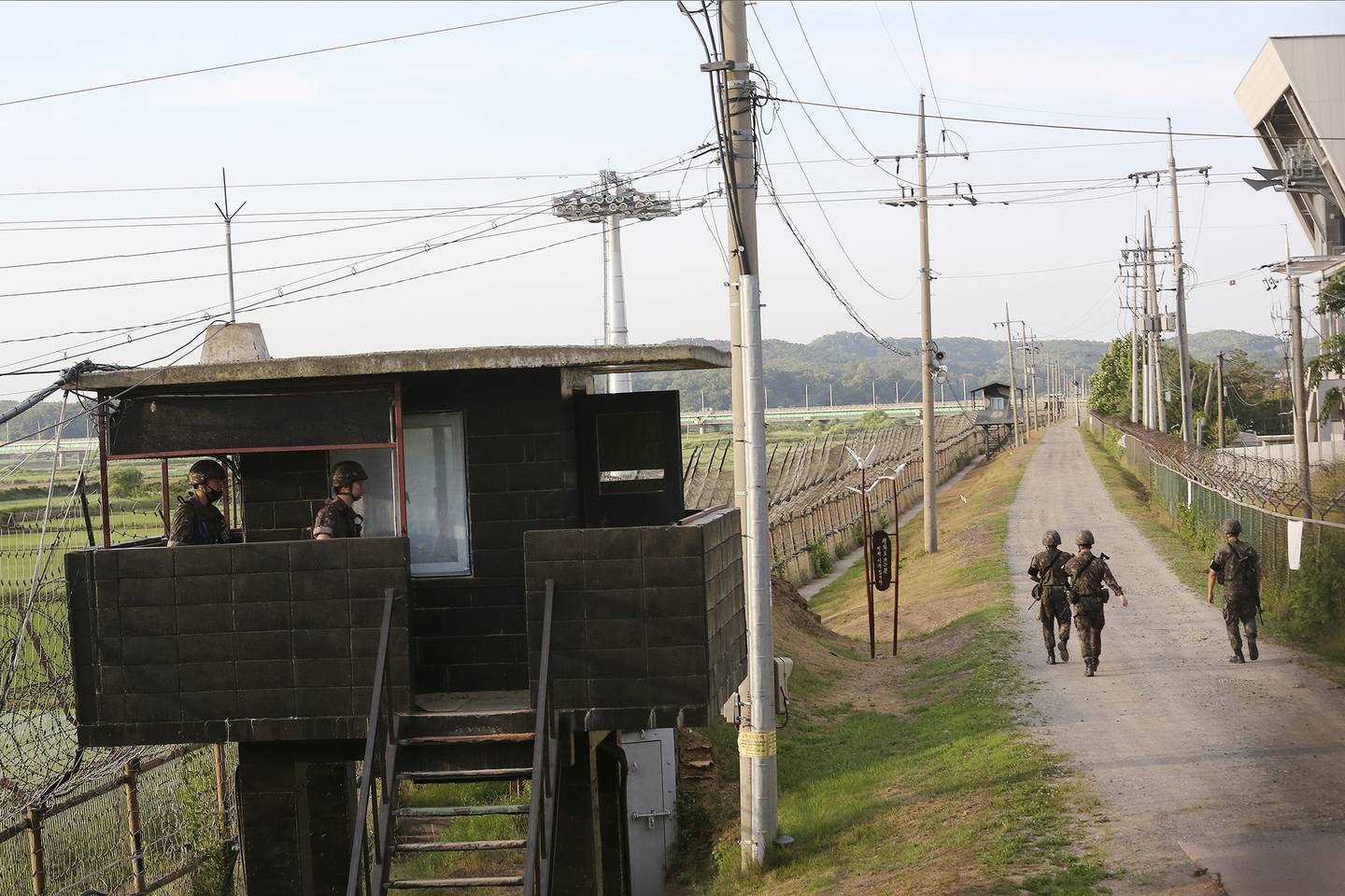 South Korean army soldiers patrol along the barbed-wire fence in Paju, South Korea, near the border with North Korea, Monday, June 15, 2020.