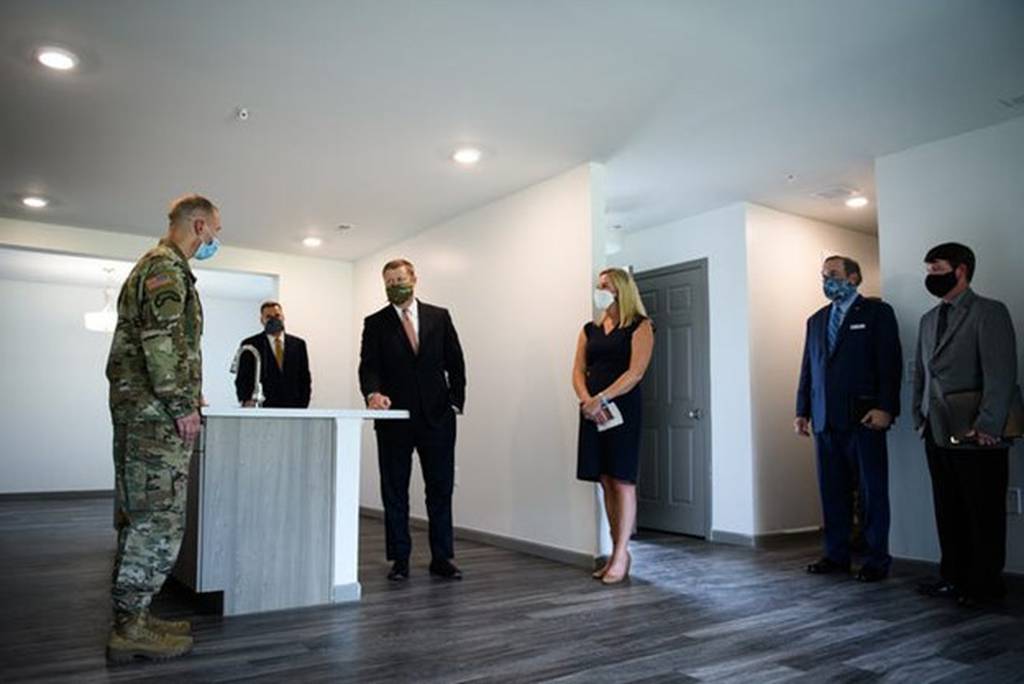 Then-Secretary of the Army Ryan McCarthy, center, tours one of the renovated homes on Fort Liberty in September 2020.