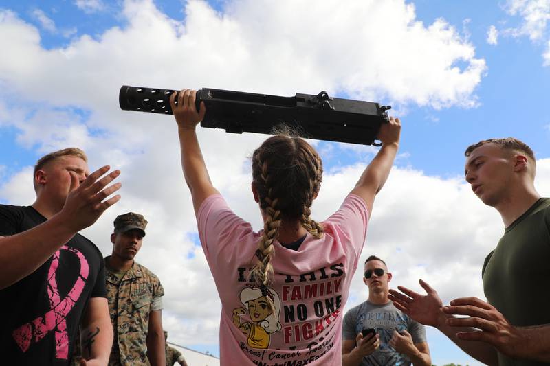Cpl. Alexandra Veal executes an overhead press with an M2 .50 caliber machine gun during the unit’s Warrior Week competition at Camp Lejeune, N.C., Oct. 15, 2020.
