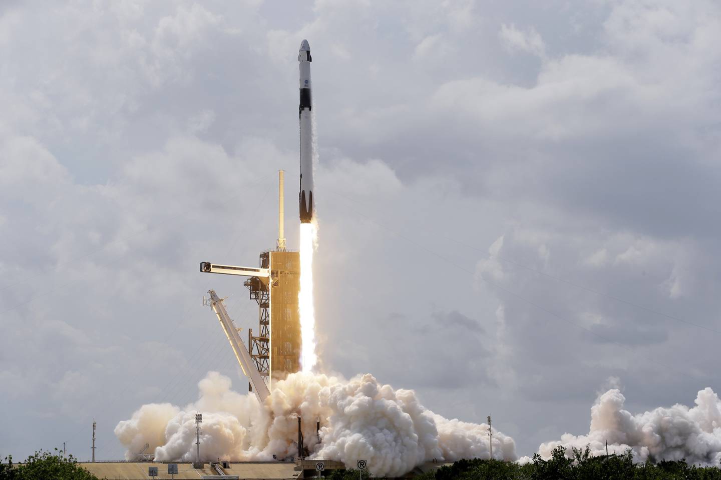 A SpaceX Falcon 9, with NASA astronauts Doug Hurley and Bob Behnken in the Crew Dragon capsule, lifts off from Pad 39-A at the Kennedy Space Center in Cape Canaveral, Fla., Saturday, May 30, 2020.