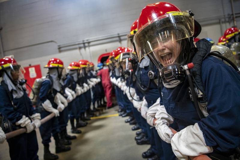 Recruits participate in firefighting and damage control training inside the USS Chief Fire Fighter Trainer on July 29, 2020, as part of the hands-on learning at Recruit Training Command at Great Lakes, Ill.