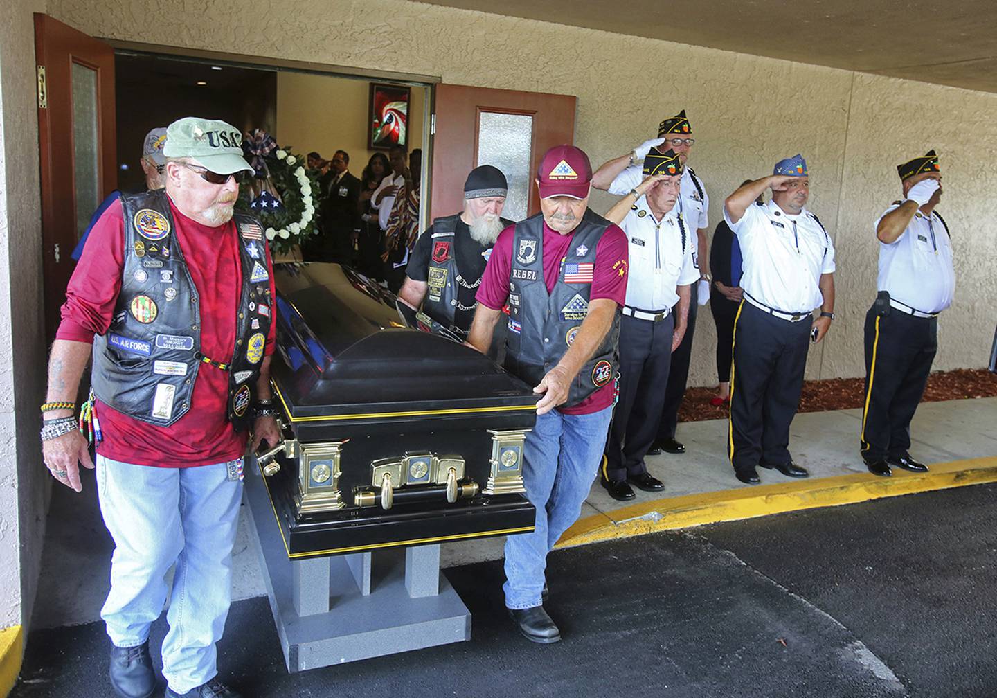 Motorcyclists from VFW Post 4287 and American Legion Post 155 present the casket of Stephen Jerald Spicer, a homeless U.S. Army veteran, during a full military honors service at Woodlawn Memorial Park in Gotha, Fla., July 18, 2019.
