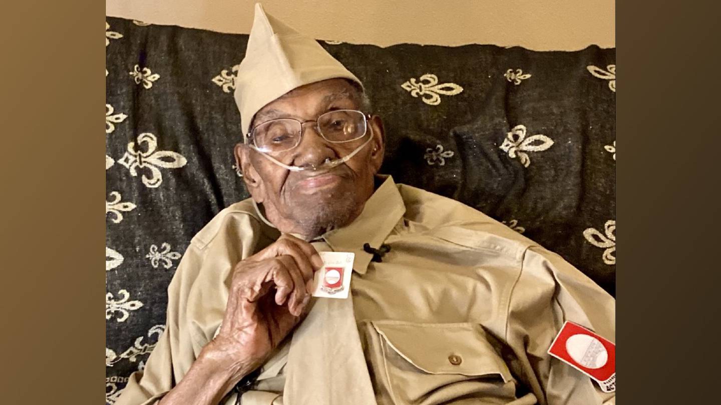 Lawrence Brooks, aged 112, holding his 91st Engineer Battalion pin and wearing his WWII reproduction summer service uniform, at home in New Orleans, Nov. 4, 2021. (Kristine Froeba)