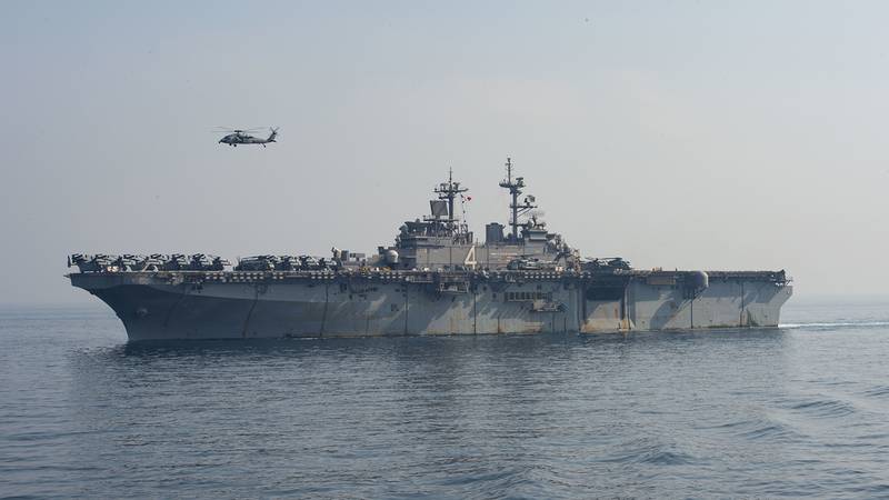 A SH-60 Sea Hawk flies over the amphibious assault ship USS Boxer (LHD 4) during a vertical replenishment-at-sea on July 19, 2019, in the Arabian Gulf.