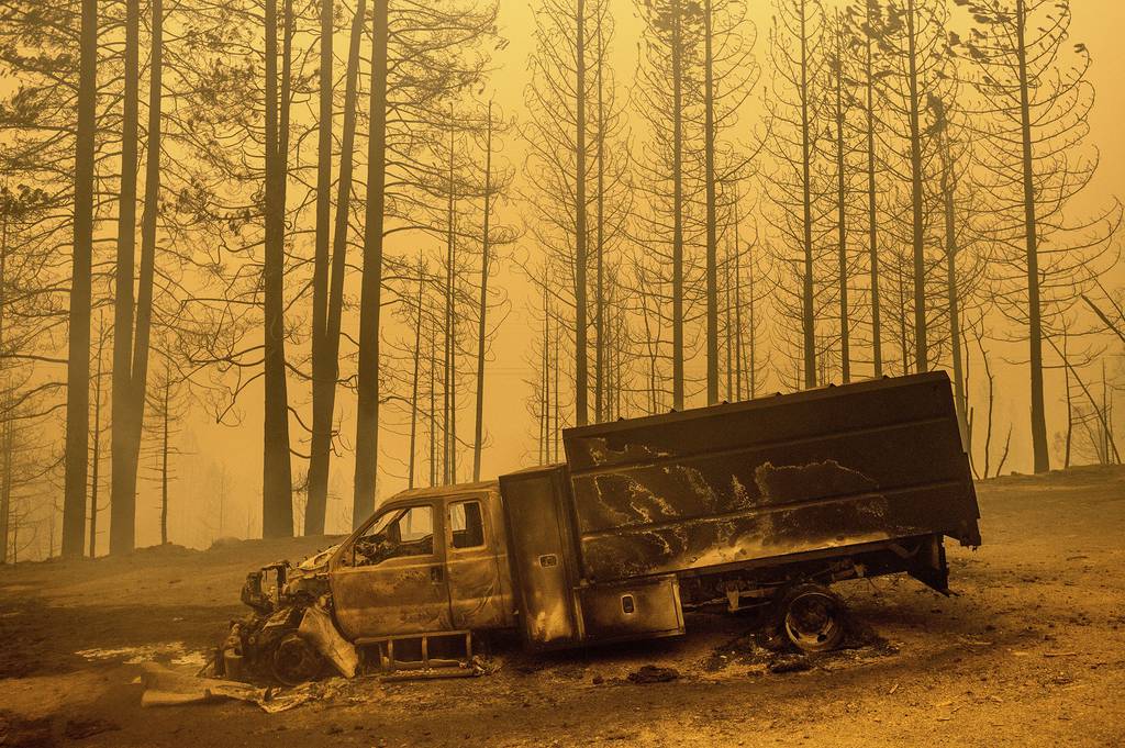 A scorched truck rests on Highway 168 after the Creek Fire burned through the area on Tuesday, Sept. 8, 2020, in Fresno County, Calif.