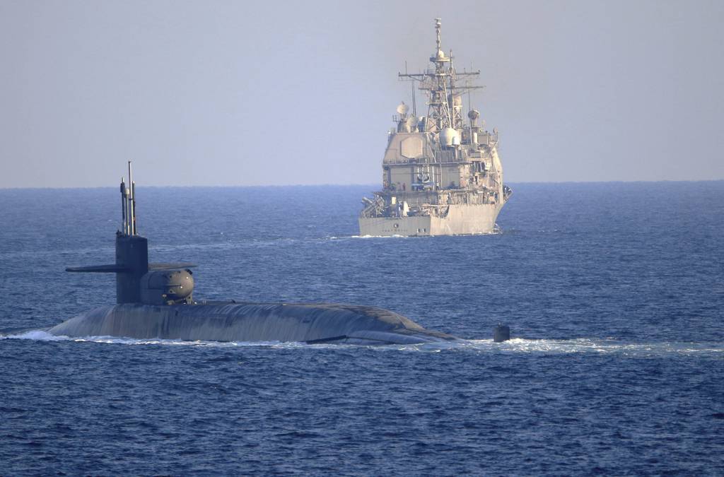 The guided-missile submarine USS Georgia, front, with the guided-missile cruiser USS Port Royal, transits the Strait of Hormuz in the Persian Gulf on Dec. 21, 2020.