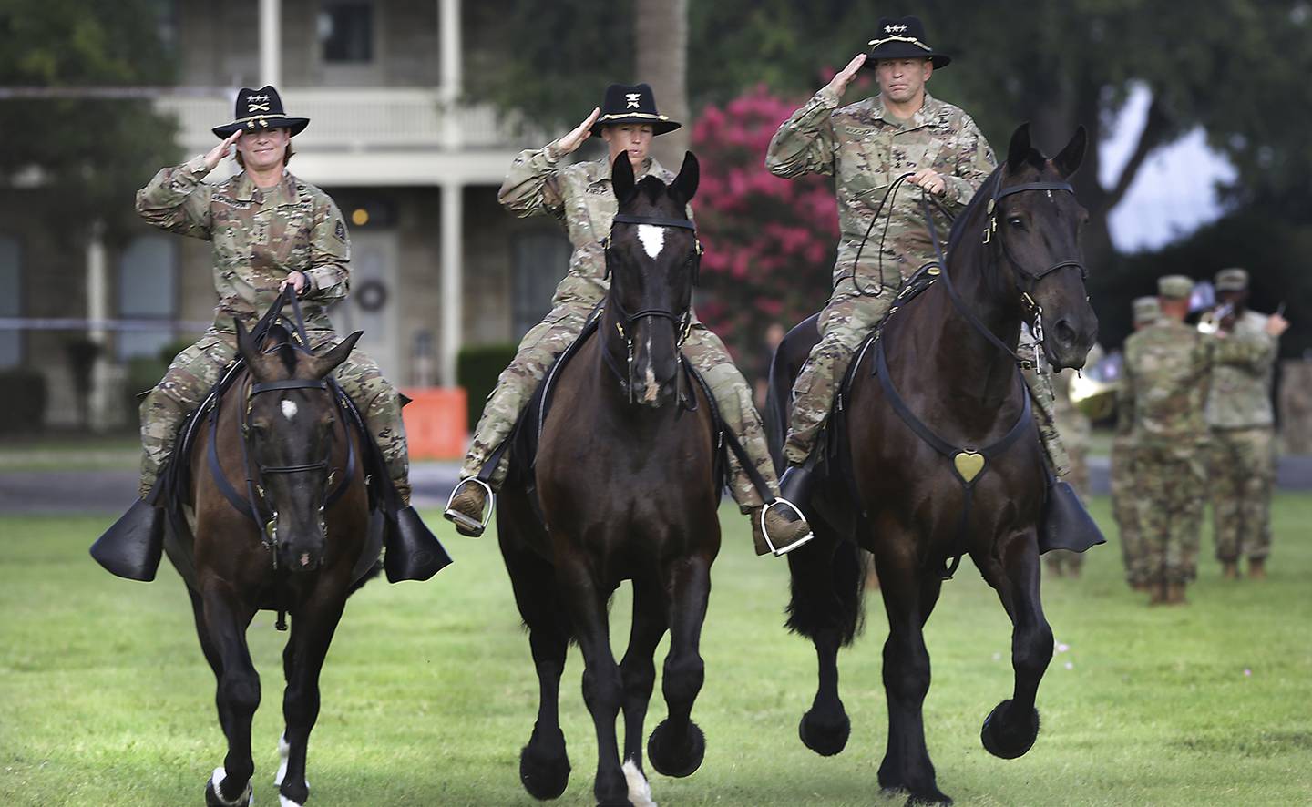 Lt. Gen. Jeffrey Buchanan, right, outgoing commander of U.S. Army North, and Lt. Gen Laura Richardson, left, incoming commander, ride with Col. Niave Knell, U.S. Army North chief of staff, to review the troops during the change of command at Fort Sam Houston on July 8, 2019.