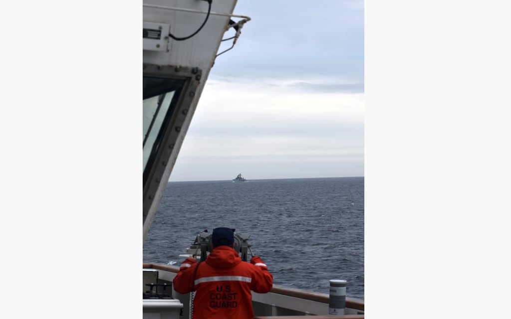 In this photo provided by the U.S. Coast Guard, a Coast Guard Cutter Kimball crew-member observes a foreign vessel in the Bering Sea, Monday, Sept. 19, 2022.