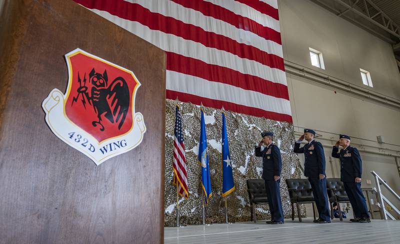 Maj. General Chad P. Franks, 15th Air Force commander, Col. Stephen Jones, outgoing 432nd Wing/432nd Air Expeditionary Wing commander, and Col. Eric Schmidt, incoming 432nd WG/432nd AEW commander, salute during the 432nd WG/432nd AEW change-of-command ceremony at Creech Air Force Base, Nevada, May 20, 2021. (Senior Airman William Rio Rosado/Air Force)