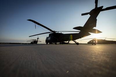 Tennessee Army National Guard Black Hawk helicopters sit on the flight line at sunrise during a training exercise at the Alpena Combat Readiness Training Center in Alpena, Mich., July 24, 2019.