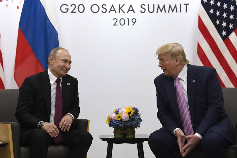 In this June 28, 2019, file photo, President Donald Trump, right, meets with Russian President Vladimir Putin during a bilateral meeting on the sidelines of the G-20 summit in Osaka, Japan.