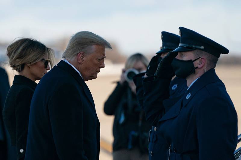Outgoing President Donald Trump and first lady Melania Trump step out of Marine One at Joint Base Andrews in Maryland on Jan. 20, 2021.