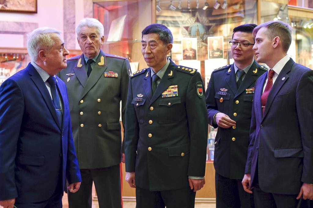In this handout photo released by Russian Defense Ministry Press Service, China's Defense Minister Gen. Li Shangfu speaks to academy teachers as Chief of the Military Academy of the General Staff of the Armed Forces of the Russian Federation Col. Gen. Vladimir Zarudnitsky stands left of him during a visit to Military Academy of the General Staff of the Armed Forces of the Russian Federation in Moscow, Russia, Monday, April 17, 2023.
