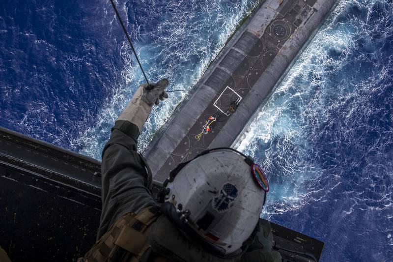 Staff Sgt. Ruben Arzate lowers a payload from an MV-22B Osprey to the Ohio-class ballistic-missile submarine USS Henry M. Jackson (SSBN 730) in the vicinity of the Hawaiian Islands on Oct. 21, 2020.