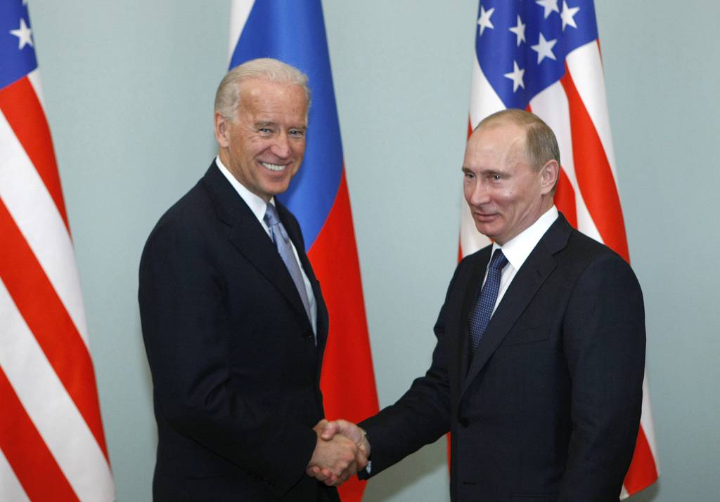 In this March 10, 2011, file photo, then-Vice President Joe Biden, left, shakes hands with Russian Prime Minister Vladimir Putin in Moscow.
