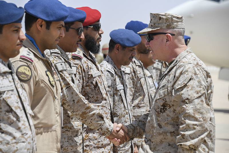 Marine Corps Gen. Kenneth F. McKenzie Jr., the commander of U.S. Central Command, right, shakes hands with airmen of the Royal Saudi Air Force on Prince Sultan Air Base, July 18, 2019.