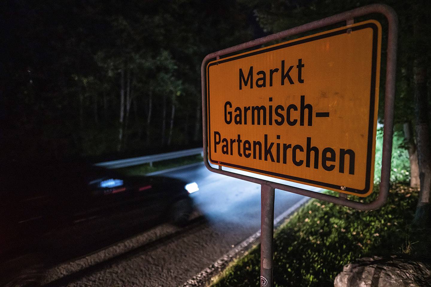 In this Sept. 13, 2020 taken photo a car drives past the place name sign in Garmisch-Partenkirchen, Germany.