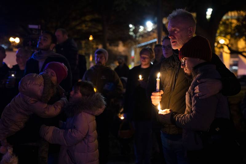 Robert McRuer, and Santy Rodelo, right, both of Washington, embrace during a candlelight vigil held in Dupont Circle, Monday, Nov. 21, 2022, in Washington, in memory of the victims of a gunman who opened fire with a semiautomatic rifle inside a gay nightclub in Colorado Springs.