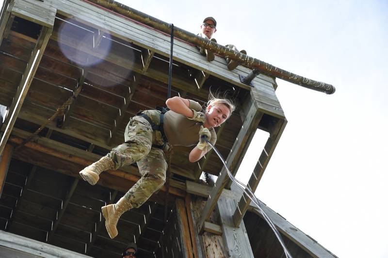 Airman 1st Class Maggie Hebert lowers herself on a rope using an "Australian Reppel" method as instructor Staff Sgt. Jon Rambow shouts directions to her from above at the Camp Gilbert C. Grafton Training Center near Devils Lake, N.D.
