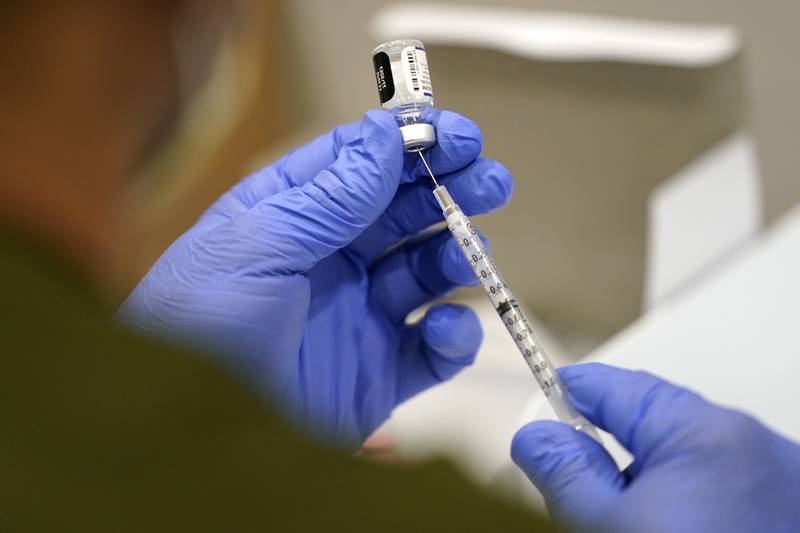 A health care worker fills a syringe with the Pfizer COVID-19 vaccine at Jackson Memorial Hospital, Oct. 5, 2021, in Miami. (Lynne Sladky/AP)