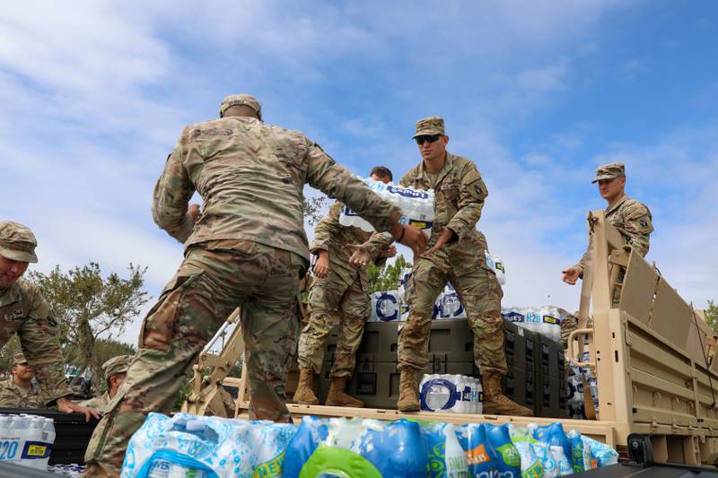 Soldiers with the Florida National Guard's Chemical, Biological, Radiological/Nuclear, and Explosive - Enhanced Response Force Package load supplies during Hurricane Ian, Sarasota, Fla., Sept. 29, 2022.