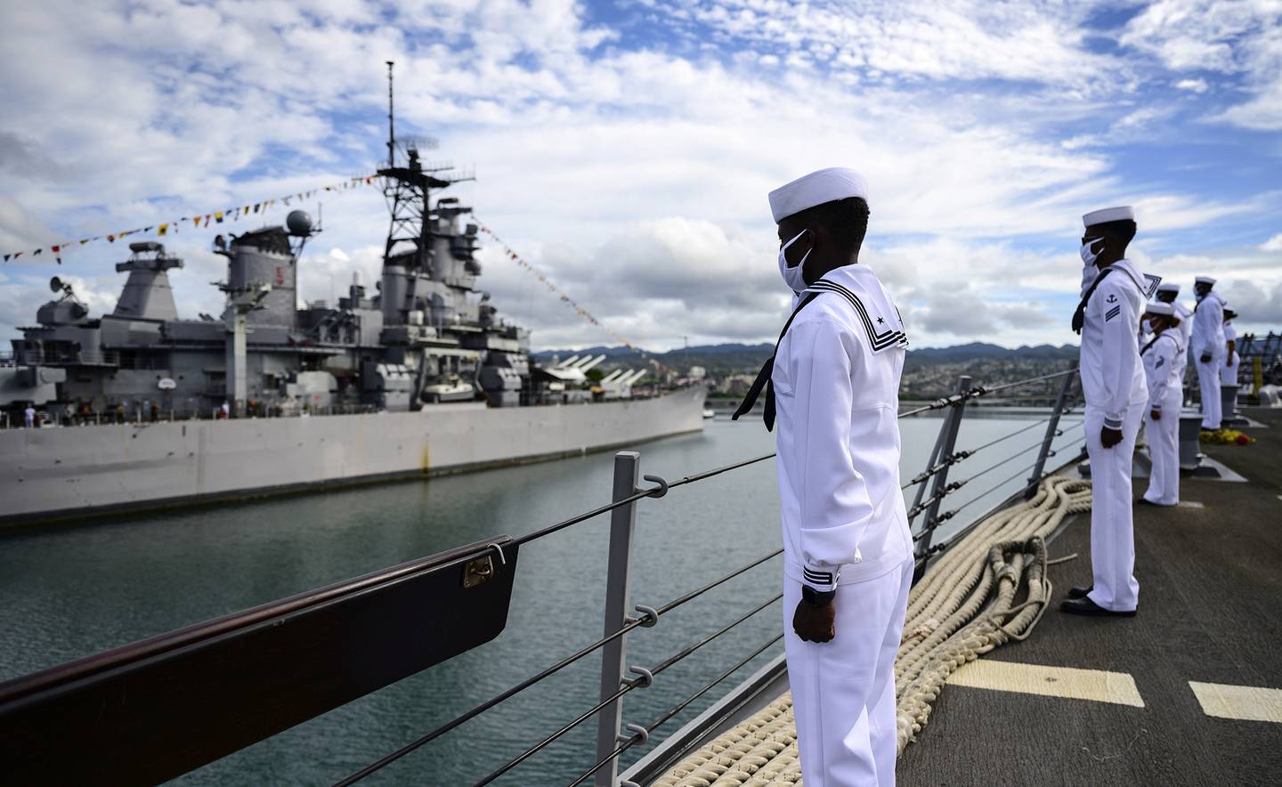 Sailors aboard the guided-missile destroyer USS Michael Murphy (DDG 112) render honors to Battleship Missouri Memorial during the official ceremony for the 75th anniversary of the Japanese surrender that ended World War II, Wednesday, Sept. 2, 2020, in Honolulu.