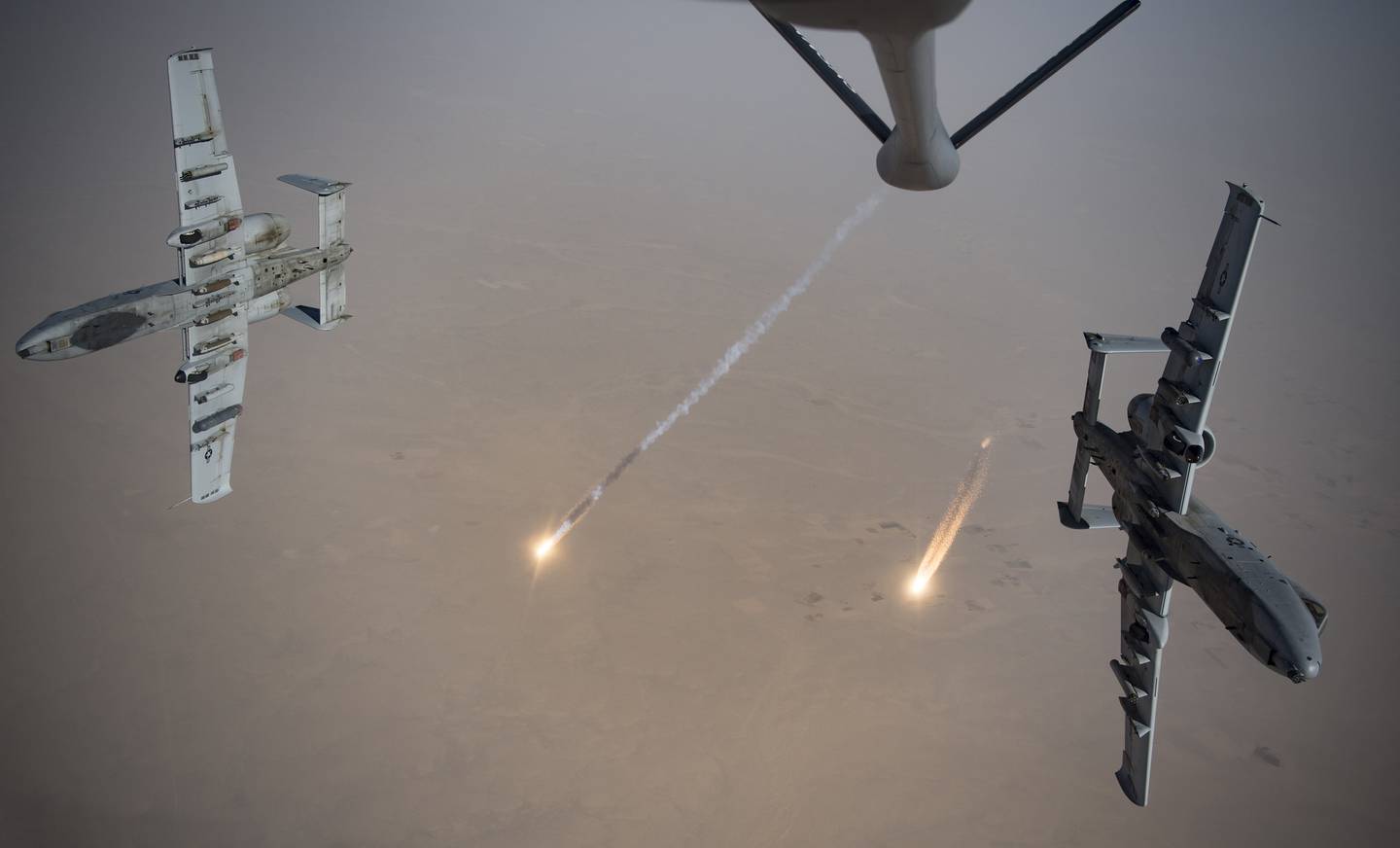 U.S. Air Force A-10 Thunderbolt IIs fire flares while breaking away after aerial refueling from a KC-135 Stratotanker out of Kandahar Airfield, Afghanistan, Aug. 15, 2019.