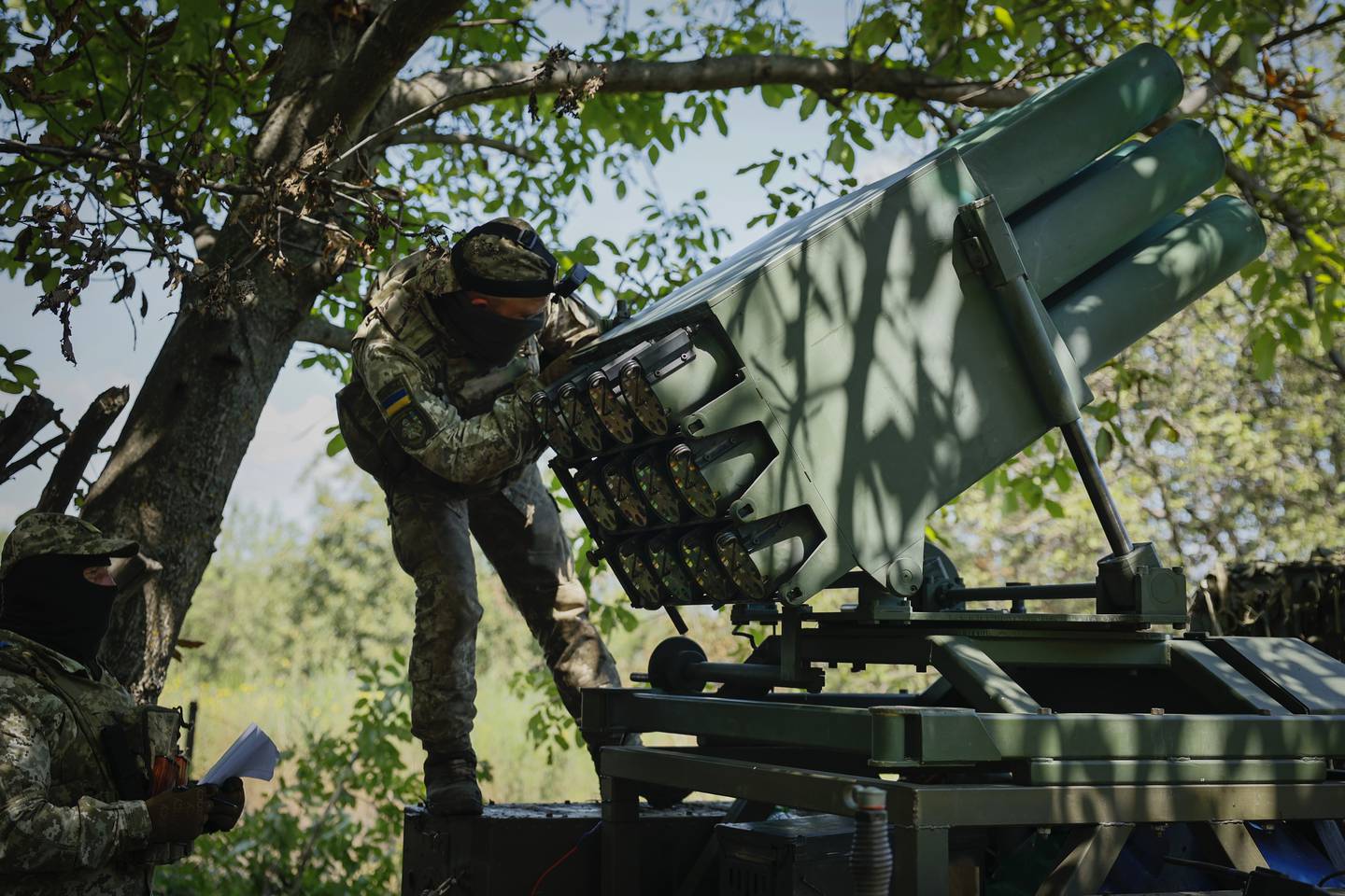 A Ukrainian soldier prepares a Croatian RAK-SA-12 128mm multiple rocket launcher to fire towards the Russian positions on the frontline near Bakhmut in the Donetsk region, Ukraine, Monday, July 10, 2023.