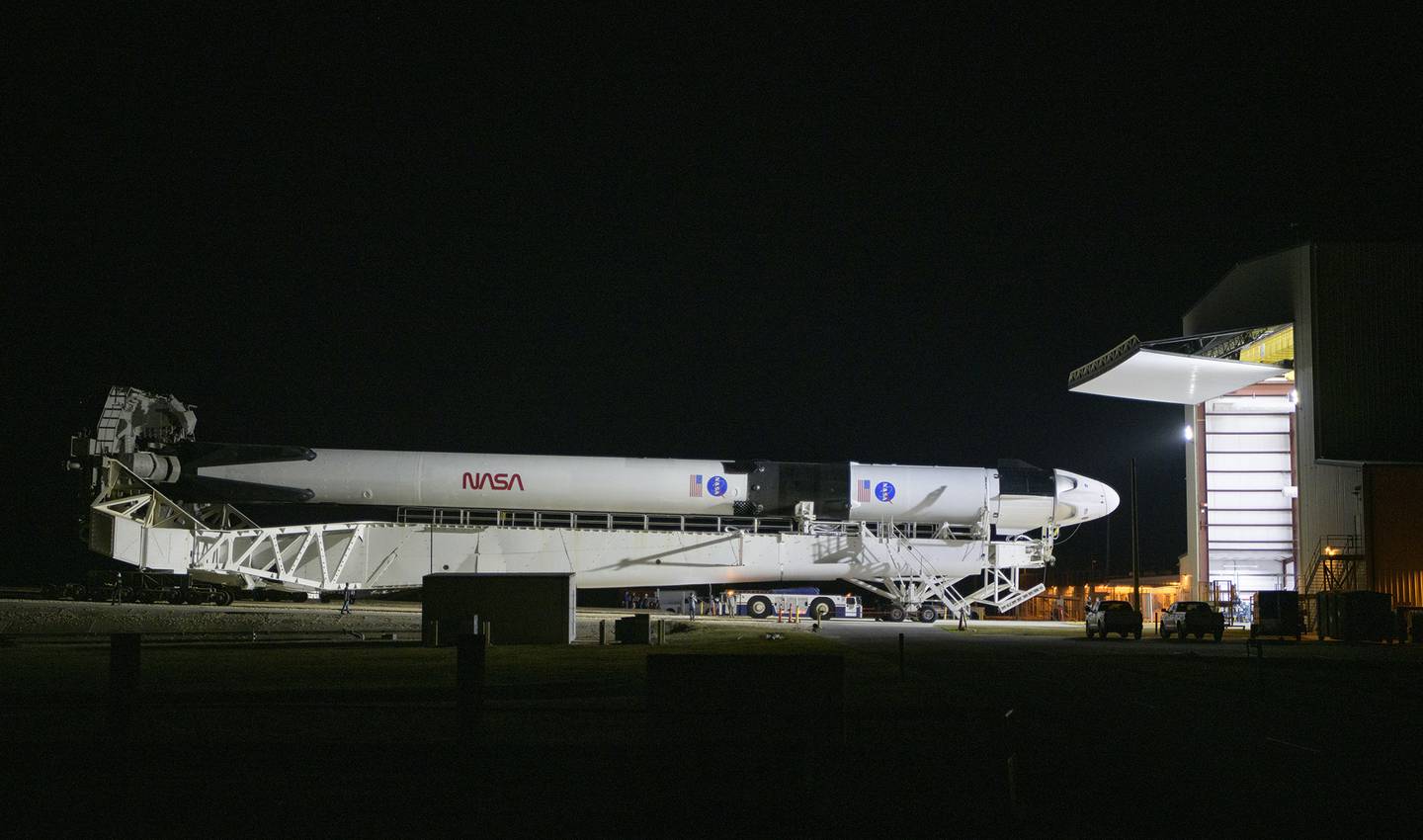A SpaceX Falcon 9 rocket with the company's Crew Dragon spacecraft is rolled out of the horizontal integration facility at Launch Complex 39A as preparations continue for the Demo-2 mission, Thursday, May 21, 2020, at NASA's Kennedy Space Center in Cape Canaveral, Fla.