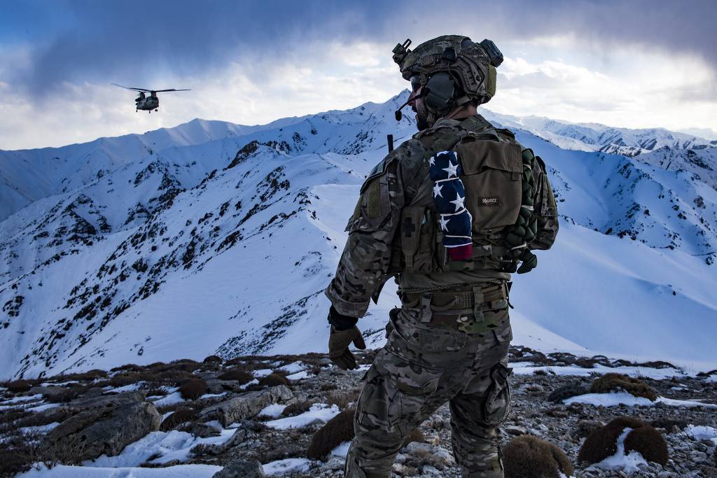 An Air Force pararescueman, assigned to the 83rd Expeditionary Rescue Squadron, communicates with an Army Task Force Brawler CH-47F Chinook during a training exercise at an undisclosed location in the mountains of Afghanistan, March 14, 2018.