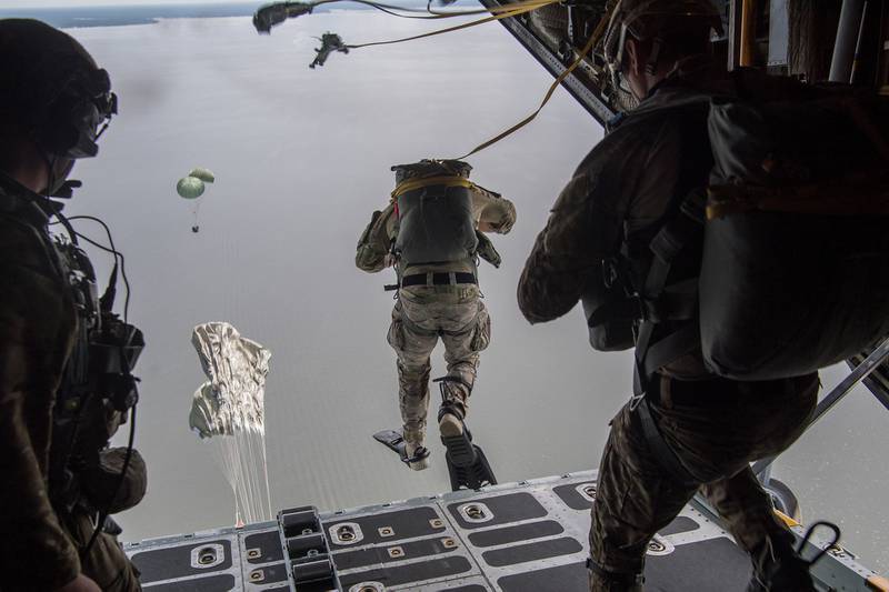Air Force Special Tactics operators conduct a static line jump out of a C-130H Hercules following a Rigged Alternate Method Boat package into the water during training at Eglin Range, Fla., Aug. 21, 2020.