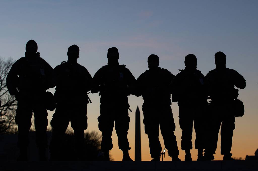 National Guard soldiers are seen in silhouette as they keep guard in front of the Capitol Building and near the Washington Monument in Washington on Jan. 19, 2021, ahead of the 59th inaugural ceremony for President-elect Joe Biden and Vice President-elect Kamala Harris.