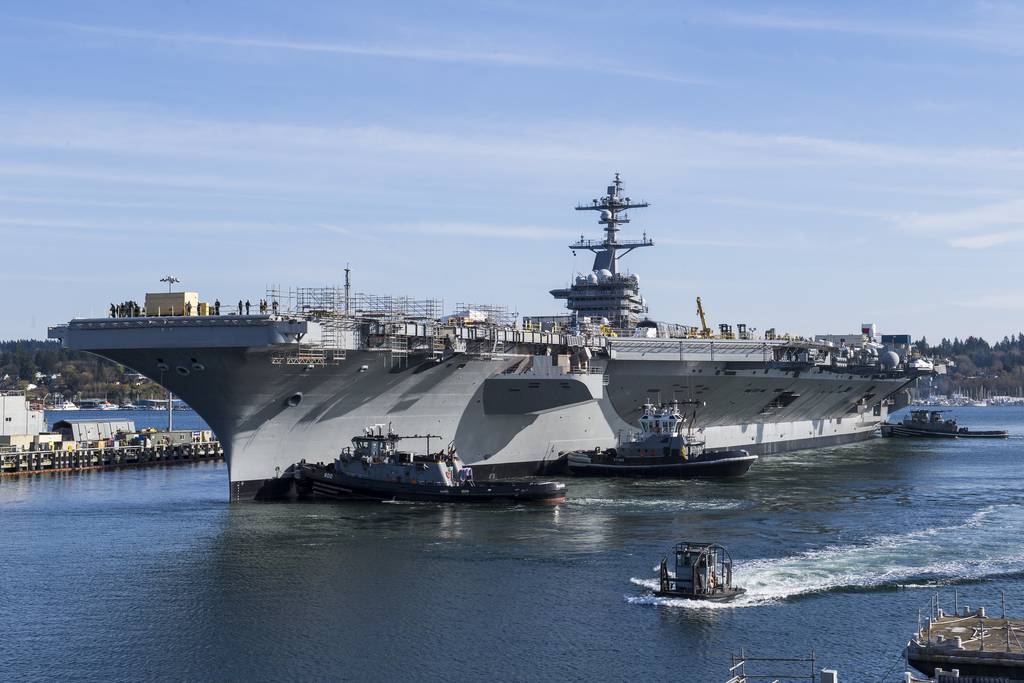 The Nimitz-class aircraft carrier USS Carl Vinson (CVN 70) performs docking maneuvers with aid of smaller watercraft at Naval Base Kitsap on April 6, 2020, in Bremerton, Wash.