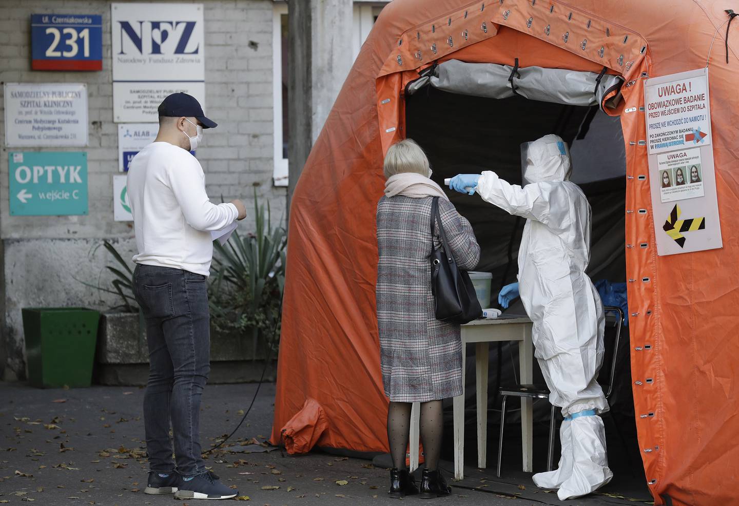 People arrive to be tested for COVID-19 in Warsaw, Poland, Thursday, Oct. 22, 2020.