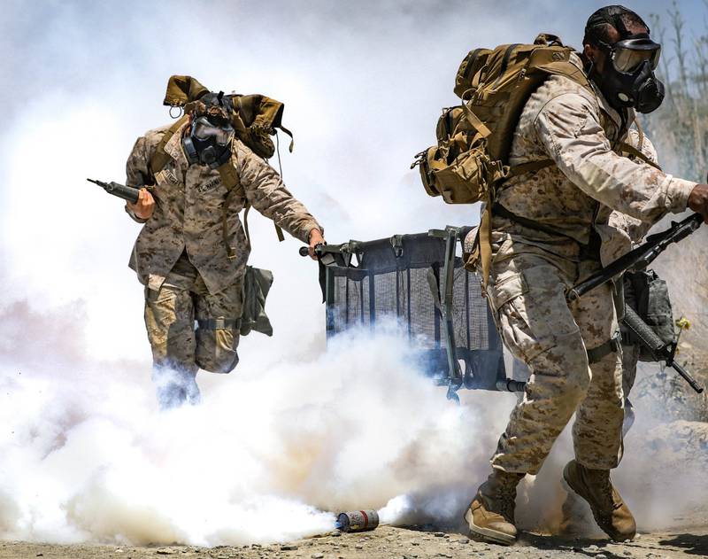 Marines run during a simulated chemical, biological, radioactive, and nuclear attack for the Command Sponsored Corporals Course at Marine Corps Base Camp Pendleton, Calif.