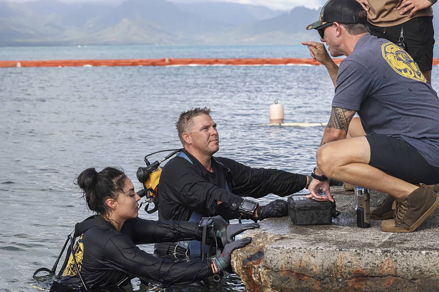 In this photo provided by U.S. Marine Corps, U.S. Navy sailors, retrieved the aircraft flight recorder from a downed U.S. Navy P-8A Poseidon and are debriefed in waters just off the runway at Marine Corps Air Station Kaneohe Bay, Marine Corps Base Hawaii, Thursday, Nov. 23, 2023.