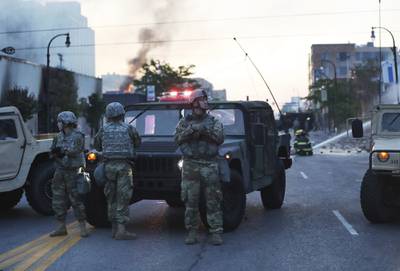 Minnesota National Guard members maintain a position protecting nearby firefighters in the wake of the death of George Floyd while in police custody earlier in the week and seen Saturday, May 30, 2020, in Minneapolis.