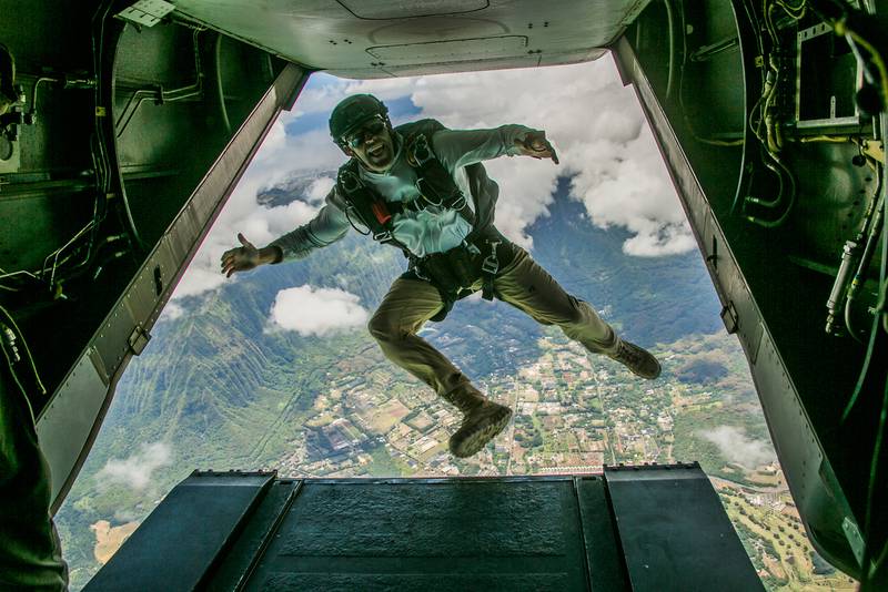 A member of the armed forces jumps out of an MV-22B Osprey during parachute training operations over Marine Corps Training Area Bellows, Hawaii, Aug. 13, 2019.