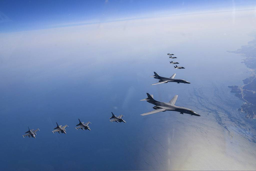 In this photo provided by South Korea Defense Ministry, U.S. Air Force B-1B bombers, center, fly in formation with South Korea's Air Force F-35A fighter jets and U.S. Air Force F-16 fighter jets, bottom left, over the South Korea Peninsula during a joint air drill in South Korea, Sunday, March 19, 2023.