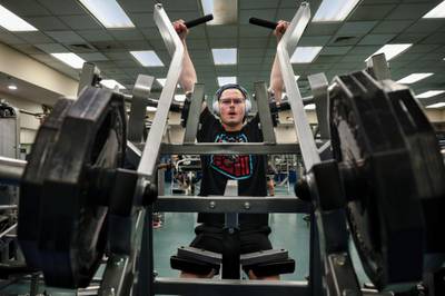 U.S. Air Force Airman 1st Class Aaron Edwards, 51st Fighter Wing public affairs specialist, performs lateral pull-downs during a back-and-bicep workout at the fitness center at Osan Air Base, Republic of Korea, Dec. 30, 2022. (Staff Sgt. Dwane Young/Air Force)