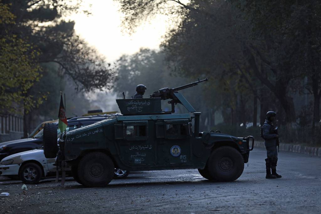 Afghan police patrol at the site of an attack at Kabul University in Kabul, Afghanistan, Monday, Nov. 2, 2020.
