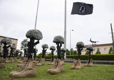 Battlefield crosses are displayed in front of the 374th Airlift Wing headquarters building during the Police Week retreat ceremony held at Yokota Air Base, Japan, May 15, 2020.
