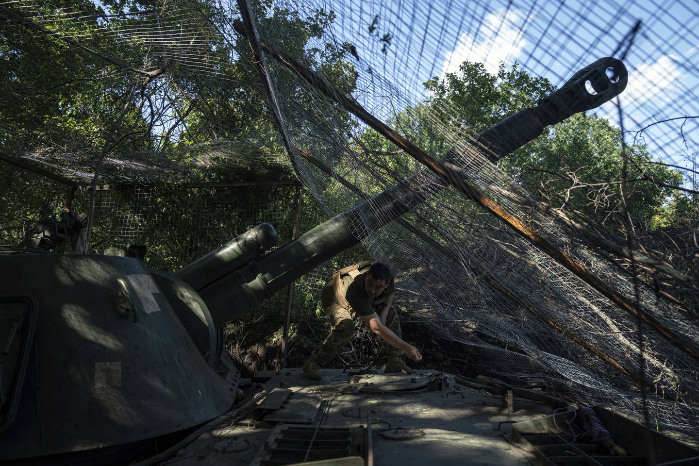 A Ukrainian serviceman of 30th brigade prepares his self propelled artillery to fire towards Russian position in Donetsk region, Ukraine, Tuesday, June 20, 2023.