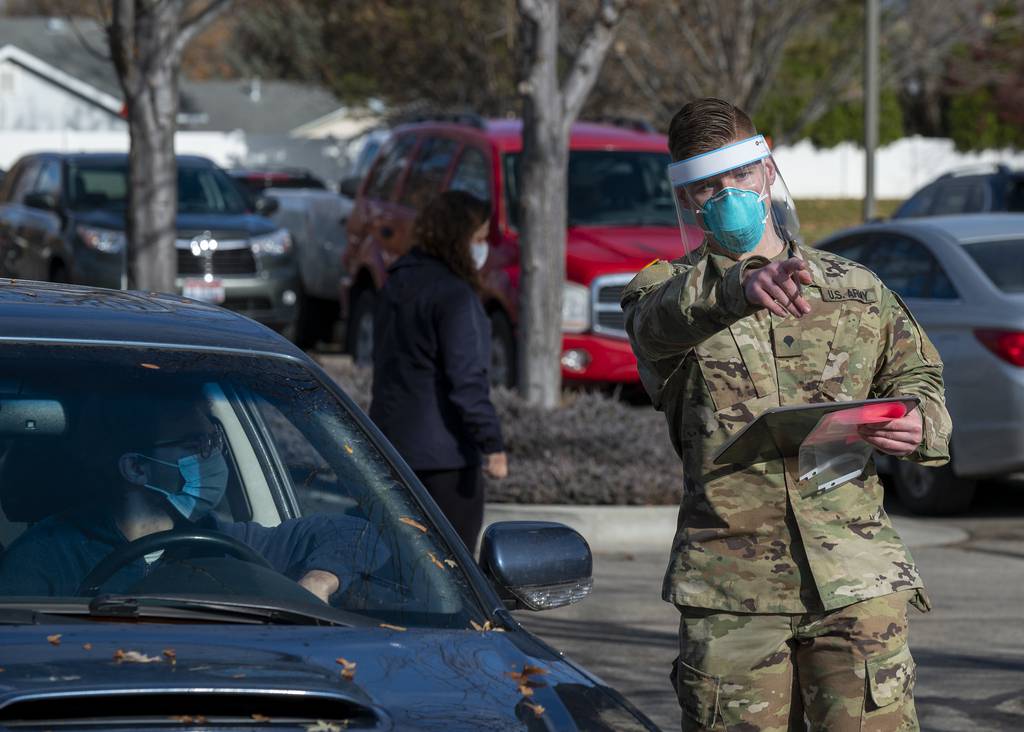 An Idaho Army National Guardsman directs a driver during a COVID-19 screening at Saint Alphonsus Medical Group Meridian Health Plaza Urgent Care, Meridian, Idaho, Nov. 19, 2020.