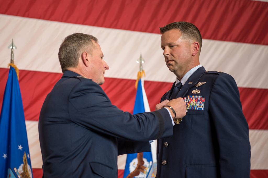 Lt. Col. John "J.T." Hourigan, right, is pinned with the Distinguished Flying Cross by Gen. David L. Goldfein.