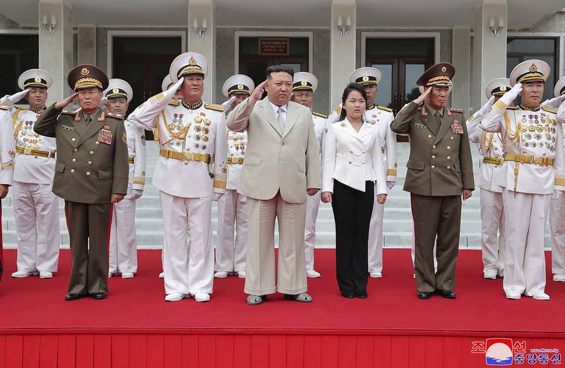 This photo provided on Tuesday, Aug. 29, 2023, by the North Korean government, North Korean leader Kim Jong Un, center, with his daughter, center right, reportedly named Ju Ae, review the honor guard during their visit to the navy headquarter in North Korea, on Aug. 27, 2023.